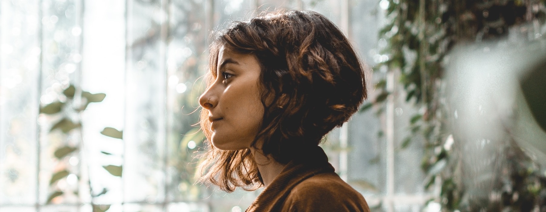 a woman standing in a green house